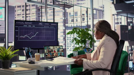 business woman in video conference reviewing annual report