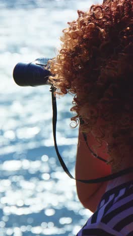 woman with binoculars viewing water