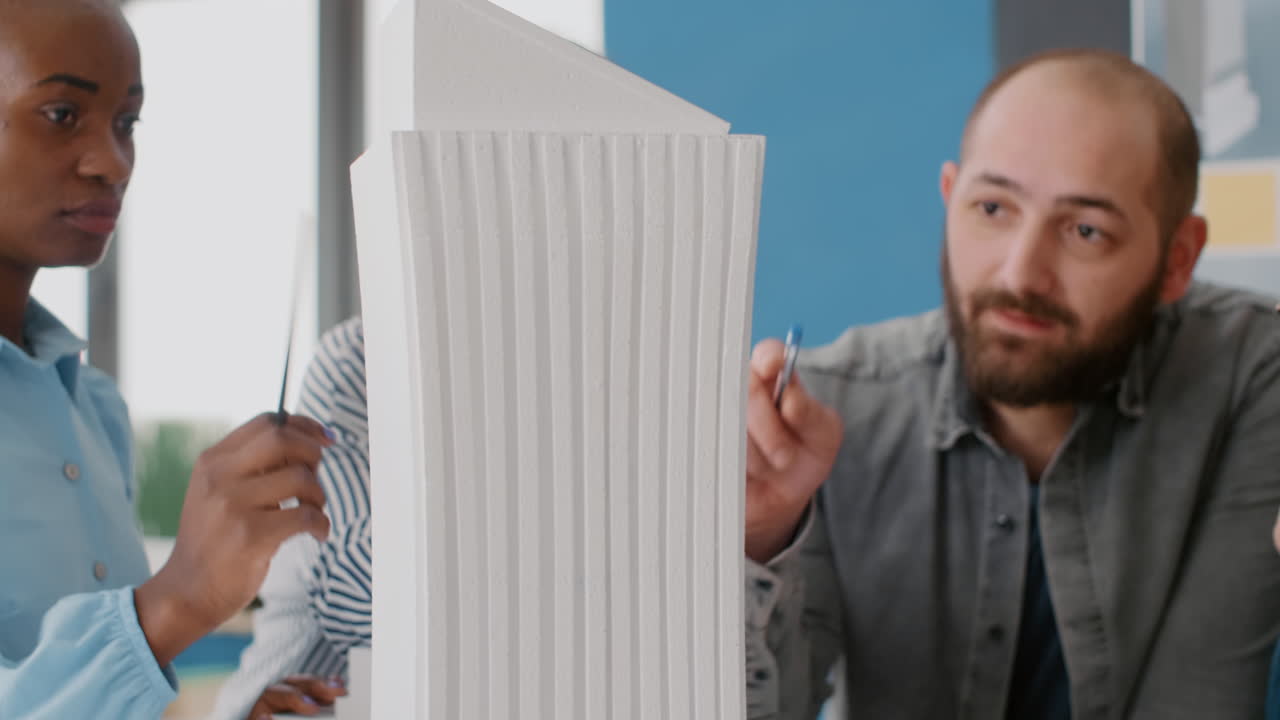 Architects collaborating on a building model