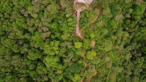 Fly-over-a-dirt-trail-on-Hill-of-the-Cross-in-Tecalitlan-reveals-the-metal-cross-monument