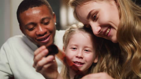 positive family looks at photos on processed film at home