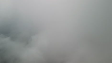 Drone view flying through thick clouds over Mount Lovcen, Montenegro