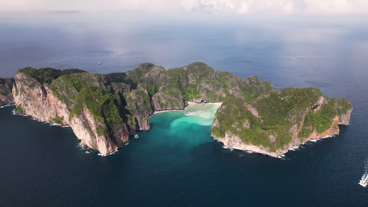 Aerial drone video of Phi Phi Leh with Maya Bay and Pileh Lagoon, Krabi province, Thailand. Aerial top view of amazing tropical island with turquoise water and white beach, famous travel destination.