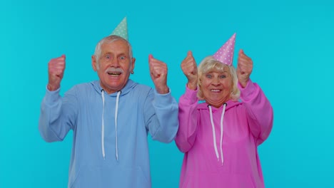 Senior-retired-couple-man-woman-grandparents-shouting,-celebrating-success-winning,-goal-achievemen