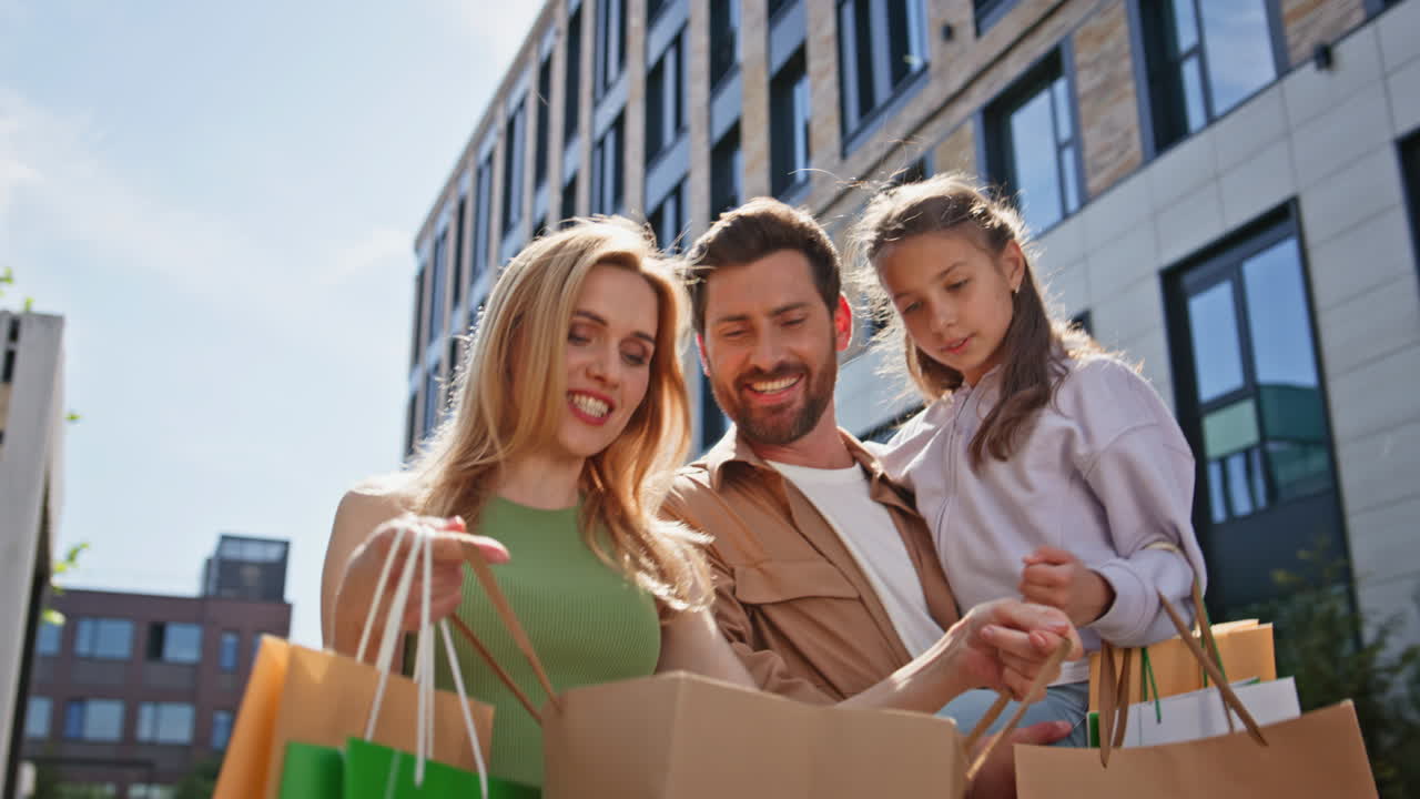 Shopping parents daughter strolling on street closeup. Couple walking with child