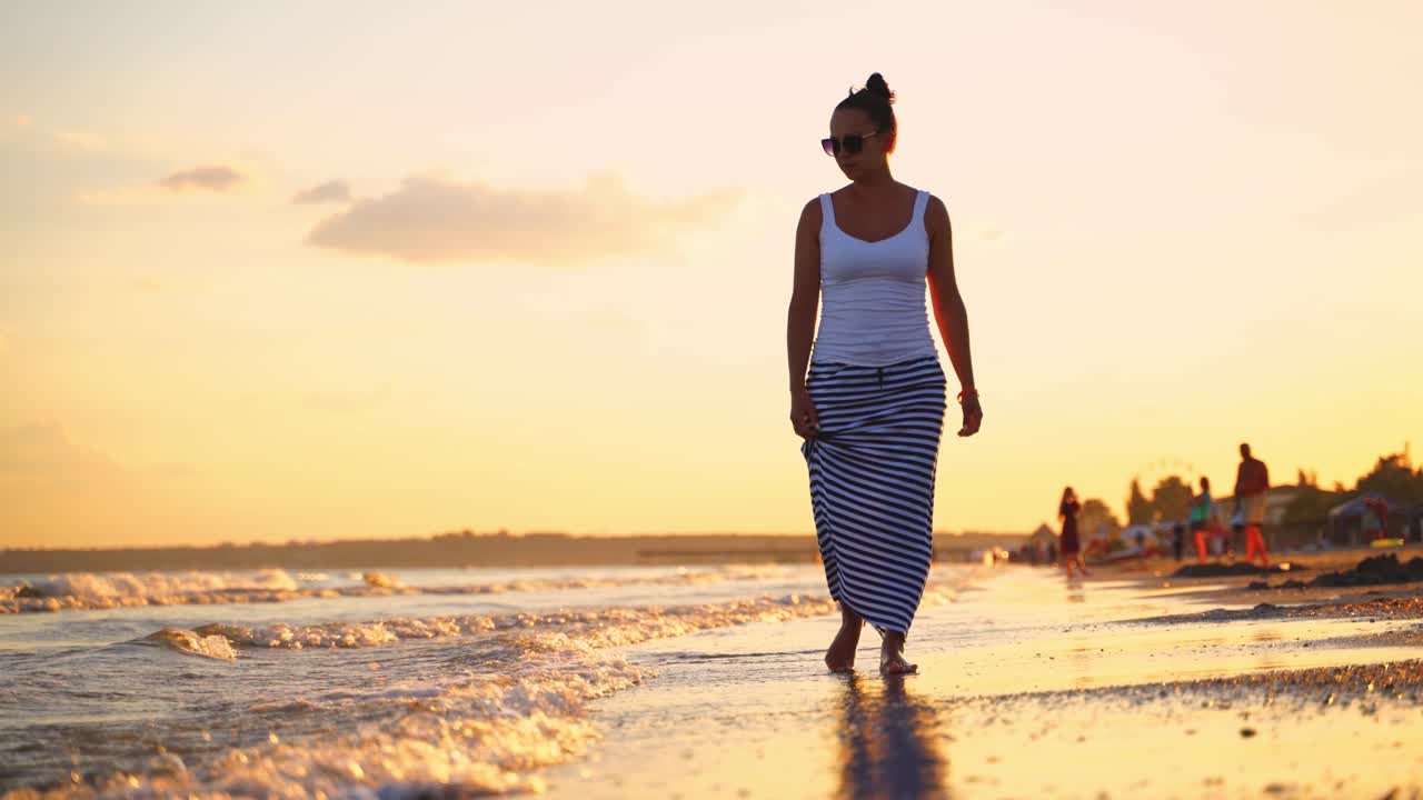 Woman walking at the beach. Young woman walking and relax on the beach