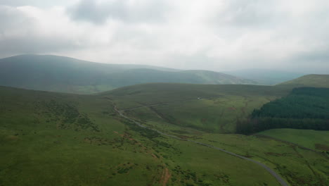 Aerial-shot-over-an-empty-mountain-road-in-the-English-Lake-District,-bright-but-overcast-day