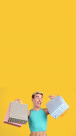 Man with Shopping Bags on Yellow Background