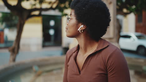 Attractive-dark-skinned-woman-waiting-friend-on-the-street