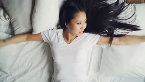 Woman Lying in Bed with Long Hair