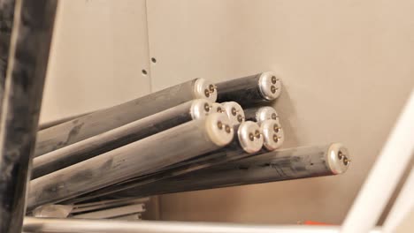 handheld camera panning left across fluorescent light tubes in storage room.
