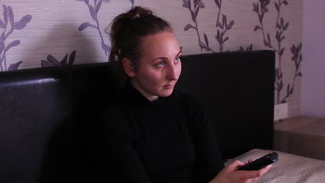 Teenage-girl-sitting-down-and-watching-TV