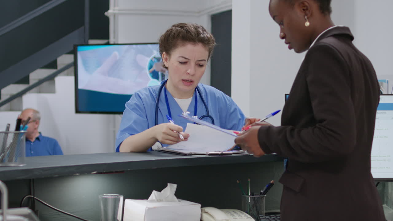 Healthcare professionals at the reception desk of a medical clinic