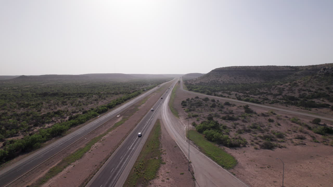 Cars and Trucks drive on I-10 in the West Texas desert