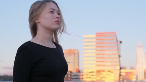A woman in a black dress gazes at a sunset city sk 4k 2025 08 04 22 23 00 utc.mov | ambiance, architecture, artistry, atmosphere