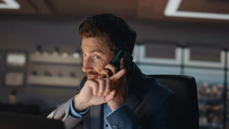nervous business man calling phone at dark room closeup. boss shouting office