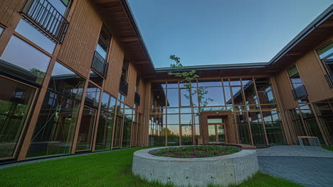 toma panorámica de un edificio de oficinas recién construido con paredes de vidrio durante el día.