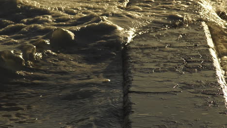 tranquil sea wave and foam rushing over tidal pool wall - static shot