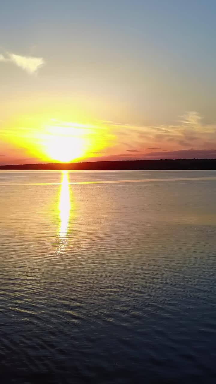 Pollution Of The Environment By The Plant. Industrial evening landscape with factory pipes and river at sunset Vertical video