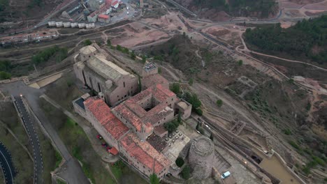 Cardona-castle-and-surrounding-town,-showcasing-historical-architecture-and-landscape,-aerial-view