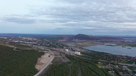 Drone-shot-of-Kiruna-iron-mine-countryside-during-summer-sunset-in-Sweden