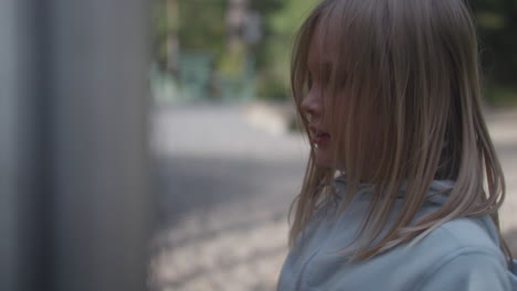 frustrated blonde little girl hitting something with frenetic hands, frustration behavior gesture, close-up