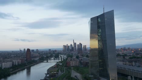 moody european central bank ecb tower in frankfurt am main germany from a drone at sunrise, little reflection 4k