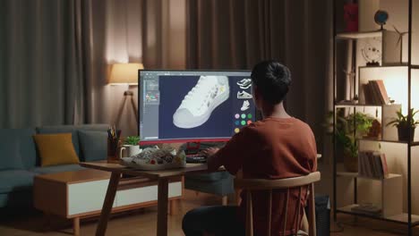 diseñador de zapatos asiático se estira después de trabajar en un escritorio en casa