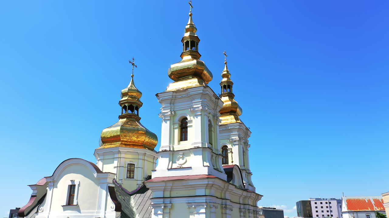 Gorgeous tops of orthodox cathedral with golden cupolas. Christian church at backdrop of blue sky on sunny day. Low angle view.