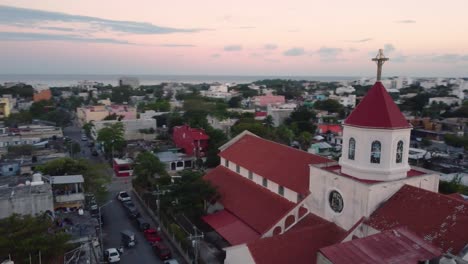 church guardering a seaside city, and a sunset embracing the horizon and the sea, mexico