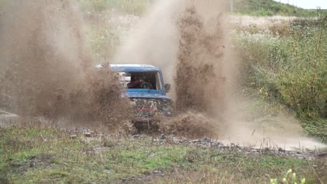 off-road vehicle driving through muddy terrain