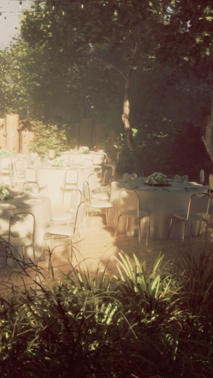 Outdoor event setup features tables and chairs in a garden location
