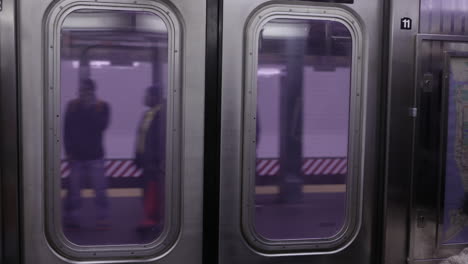 nyc subway train. train leaving, view from inside train - new york city subway. slowmotion