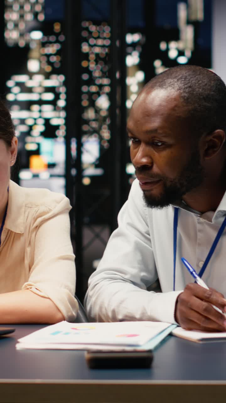 Vertical Video Diverse business team working together in office late at night