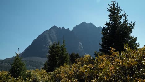 stunning nature landscape view of the incredible red castle peak up a backpacking trail in the high uinta national forest between utah and wyoming with a fishing lake below and pine trees surrounding