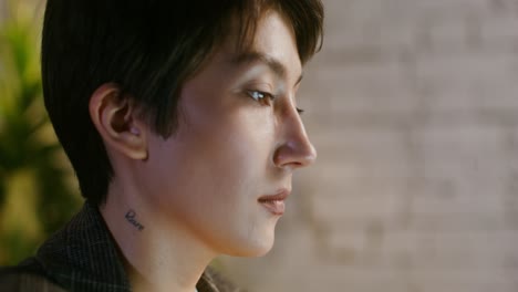 close-up profile of a woman with a neck tattoo