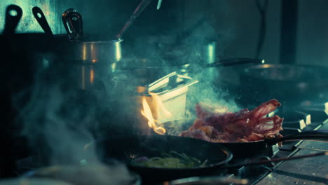 chef cooking meat and vegetables in sizzling hot pans