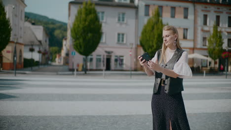couple and woman taking a selfie in a european city square