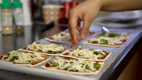 Close-Up-Preparation-of-Flatbread-Pizza-With-Sweetcorn-Being-Placed