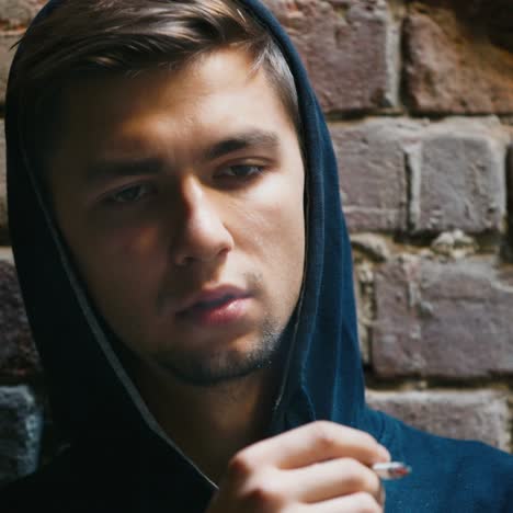 sad young man smoking in an abandoned building 1