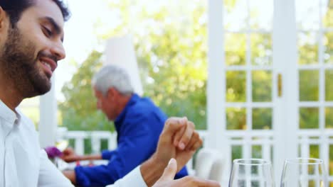 couple toasting glasses of red wine in restaurant