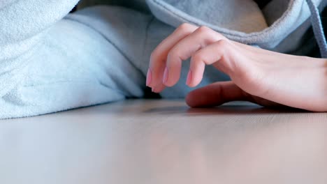 closeup woman's hand nervously knocking fingers on the table.