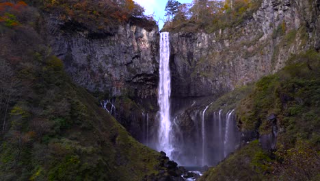 beautiful tall waterfalls in shadows with sunlight slowly poking in