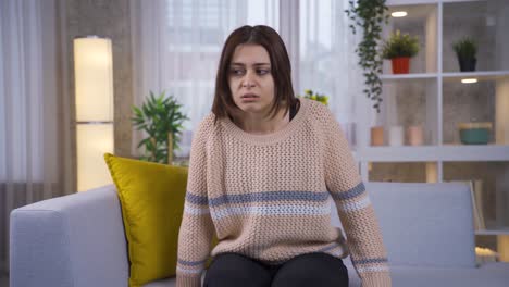 paranoia young woman looking around at home in fear and panic.