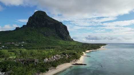 Mauritius-island-with-houses-on-the-beach-and-Le-Morne-Brabant-mountain,-establishing-shot