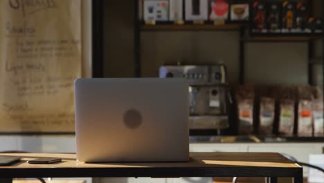 laptop on table in cafe 4k