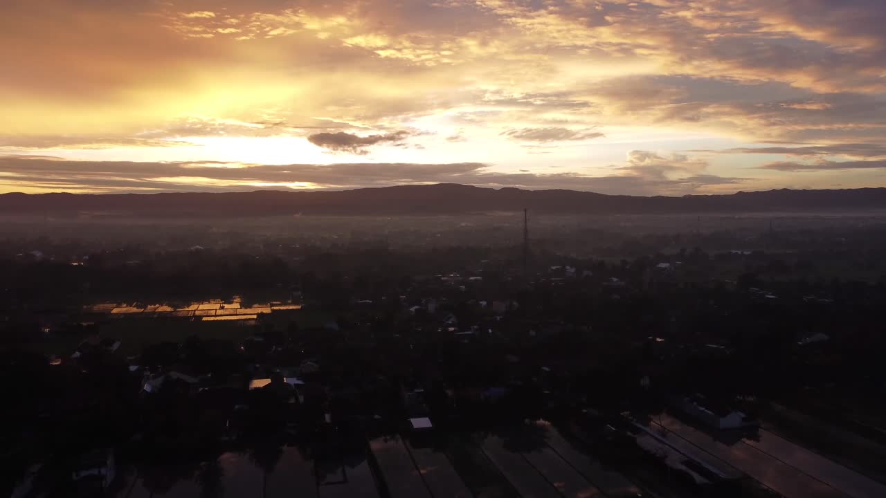 Sunrise over Rural Village with Rice Paddies