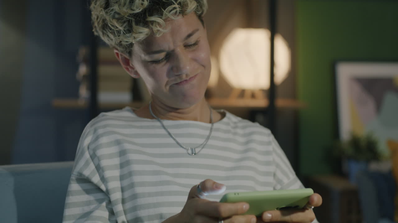 Woman Playing Mobile Game at Home