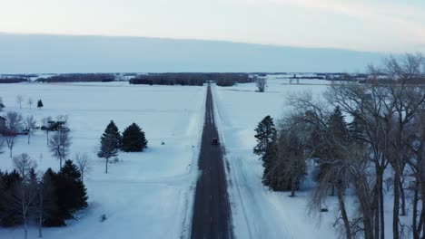 Cinematic-aerial-view-of-an-icy-road-in-rural-Minnesota