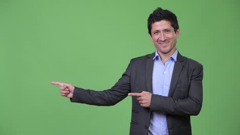 happy hispanic businessman showing something